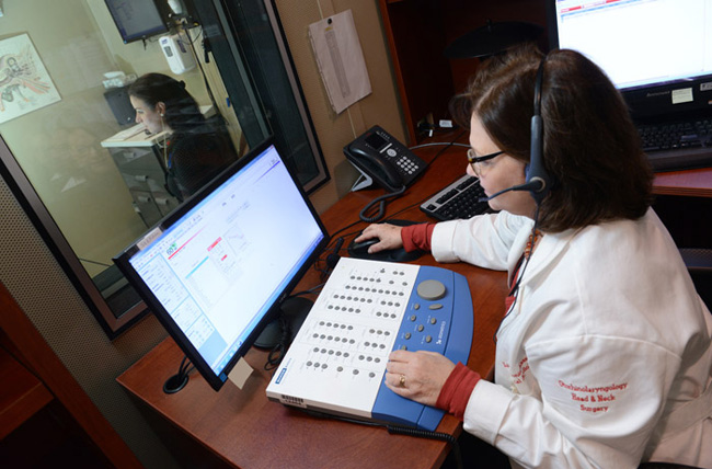 Audiologist conducting test